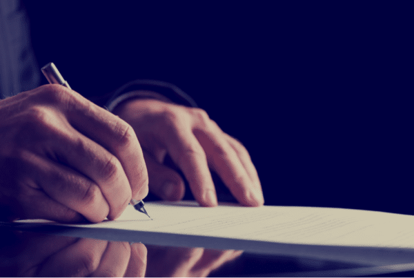 Close up of hands signing a will