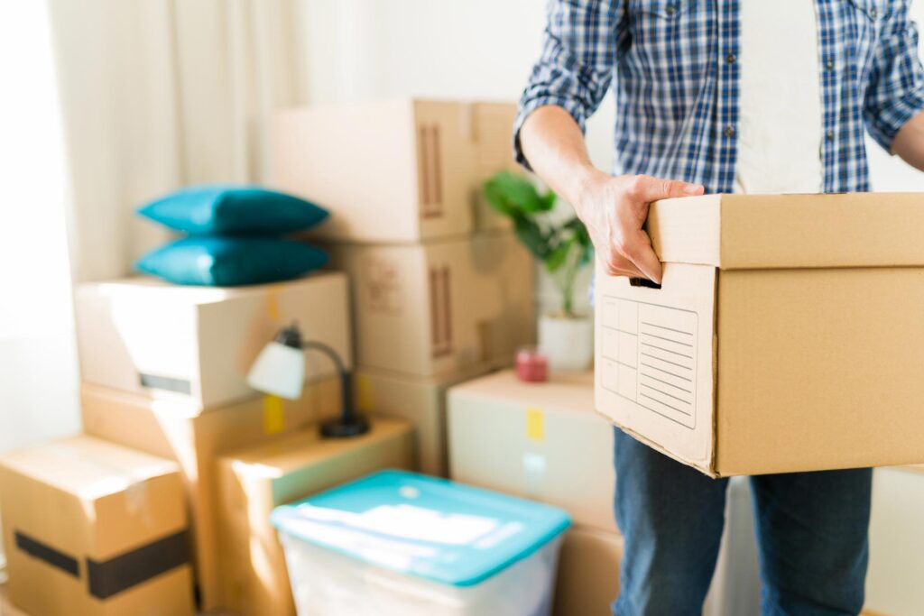 man carrying moving boxes