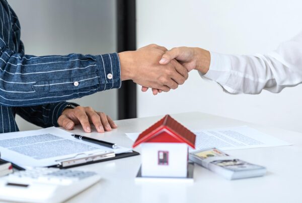 real estate agent and customers shaking hands