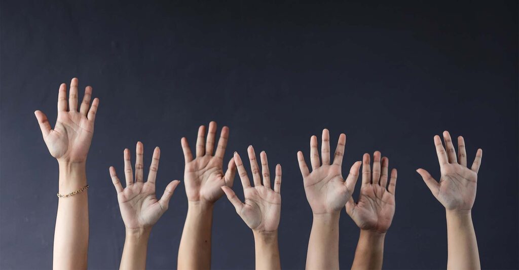 multiple hands raising