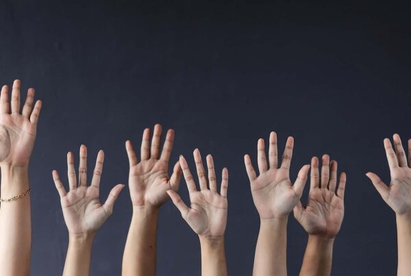 multiple hands raising