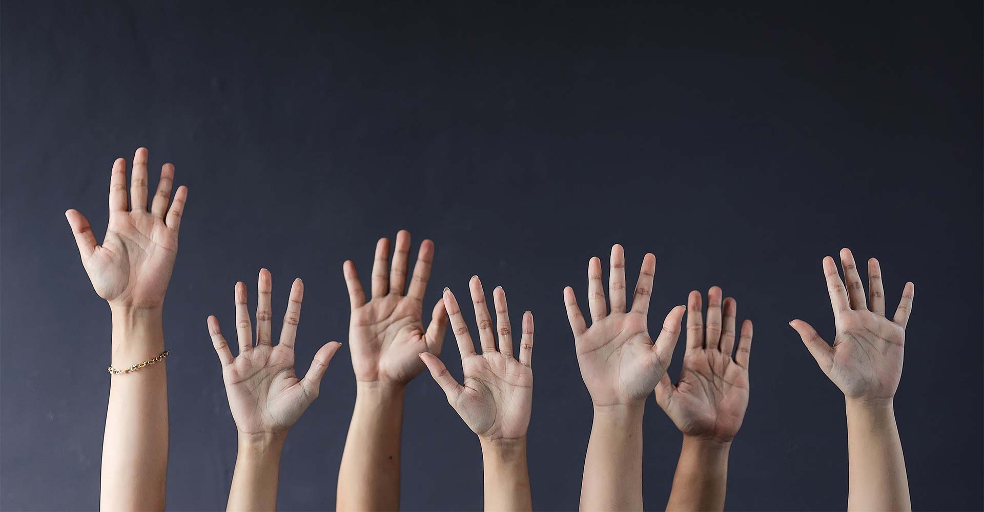 multiple hands raising