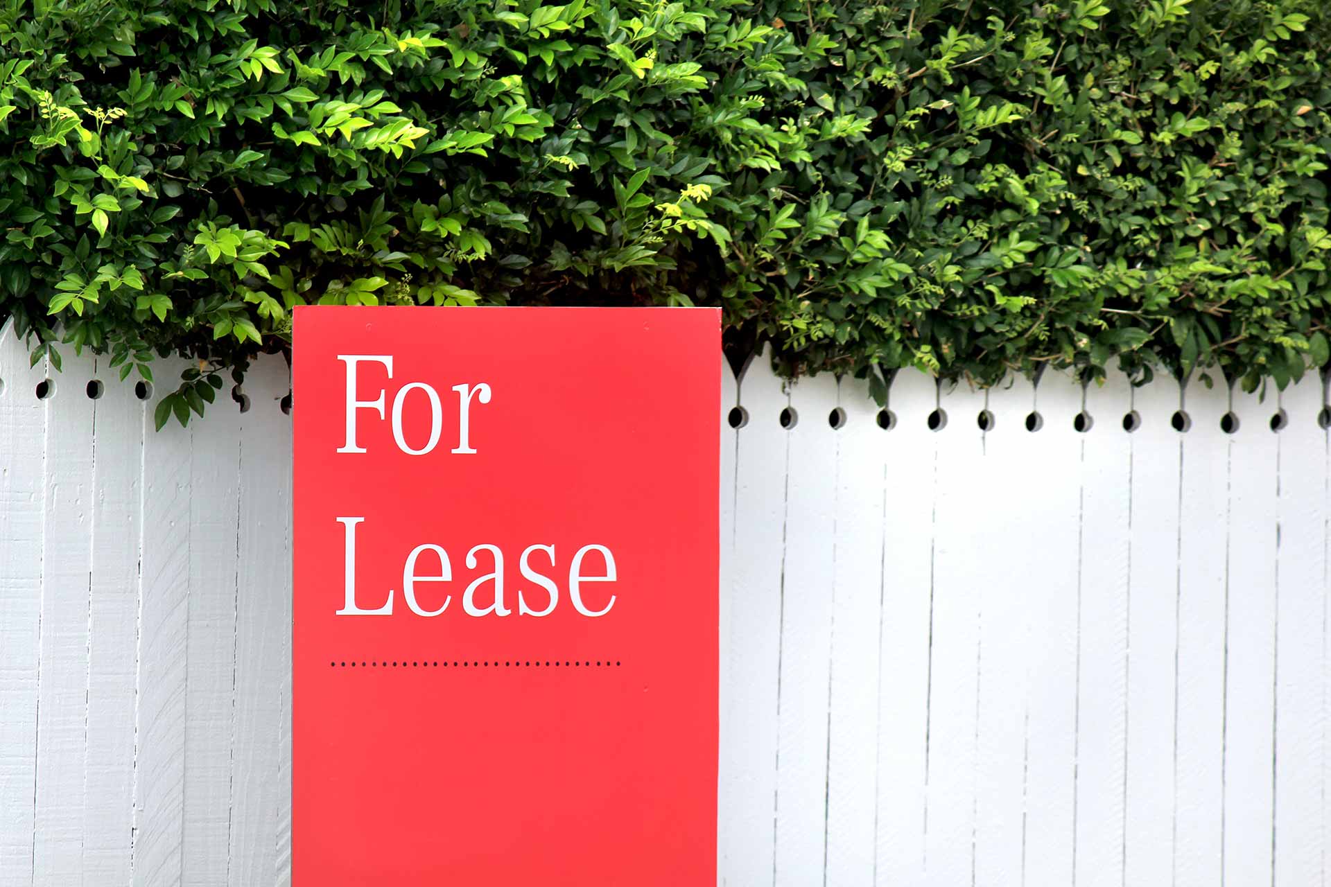 Red for Lease sign outside fence